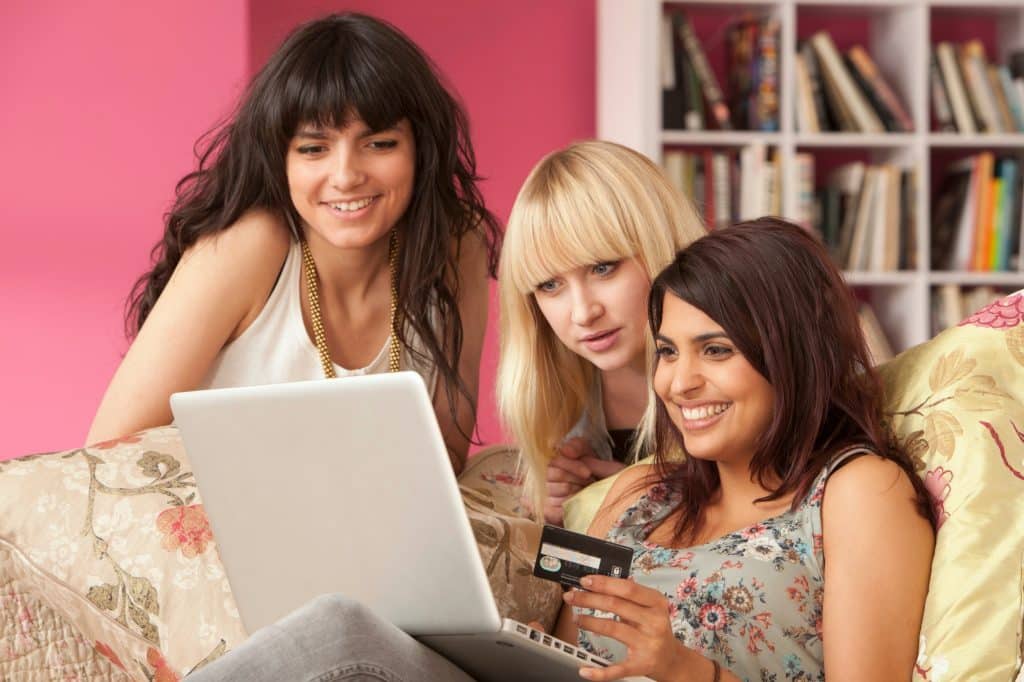Three young women shopping on computer